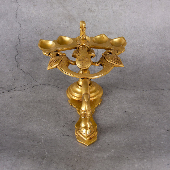 Brass panch mukhi diya 5-face aarti lamp — lifestyle in-use shot