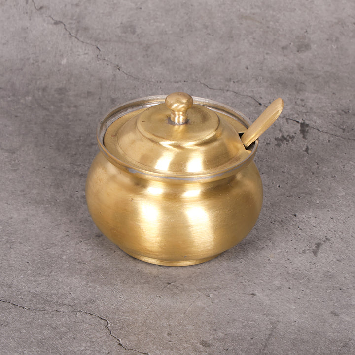 Brass ghee pot pital ghee dani ghilodi — close-up material